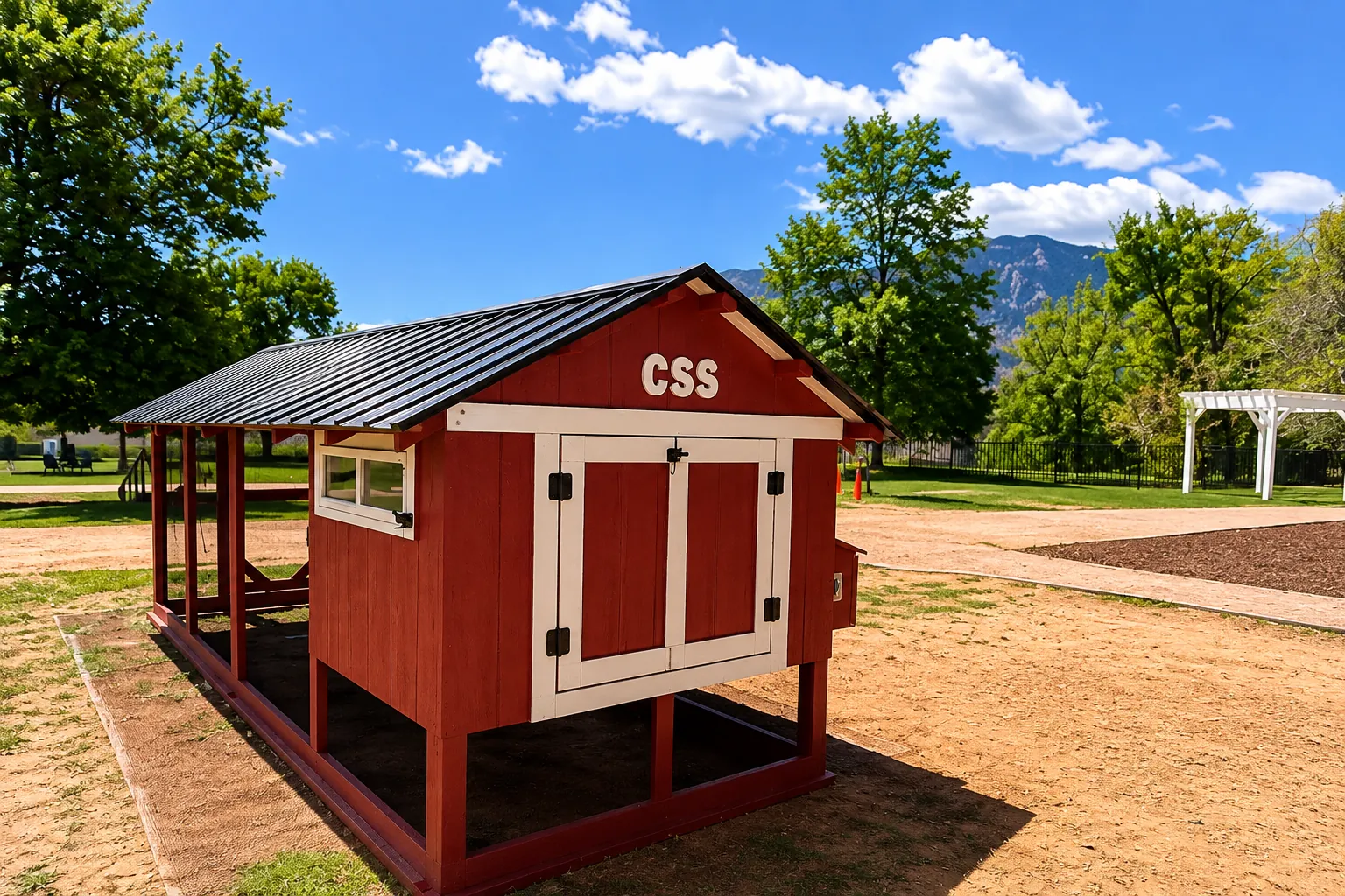 The finished red Barn House Coop for The Colorado Springs School, installed on the school grounds