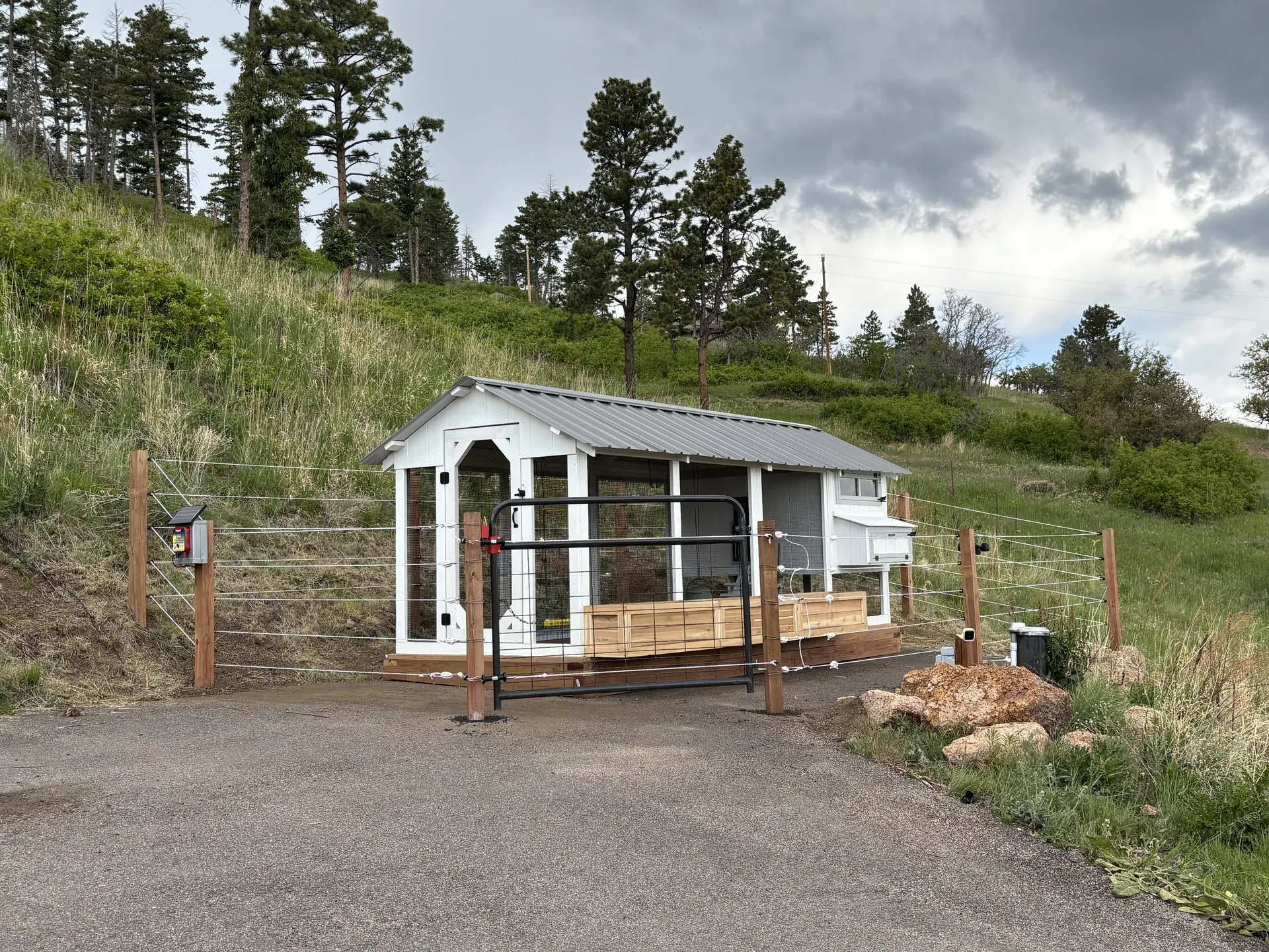 The Barn House Coop with cedar planter boxes behind a five-strand electric fence, Larkspur, Colorado